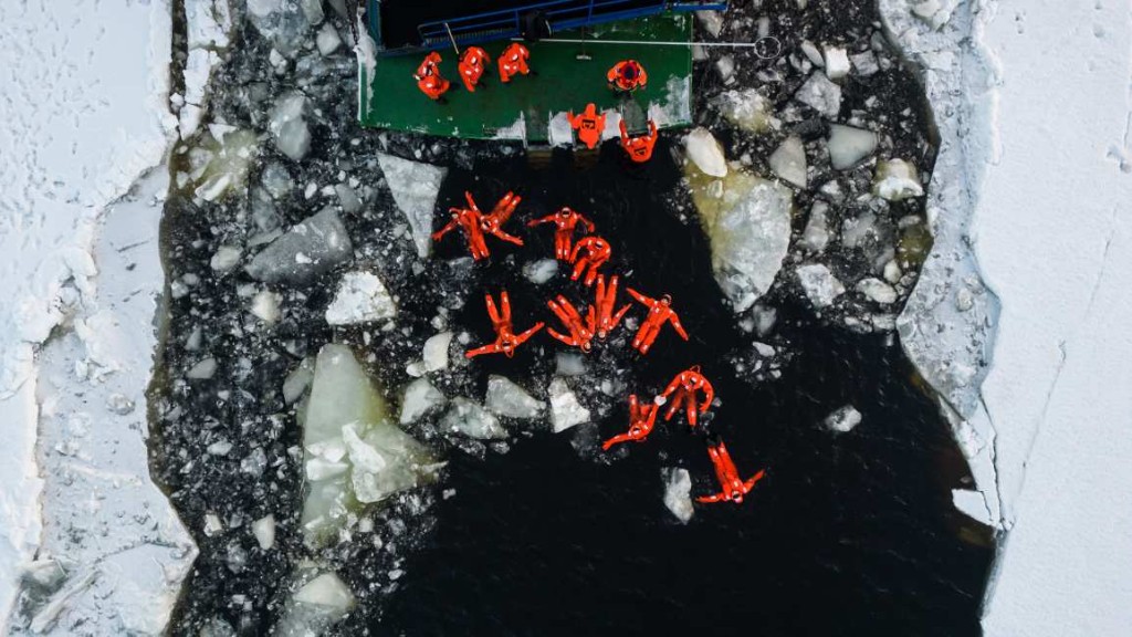 Guests floating in orange suits in the ice channel