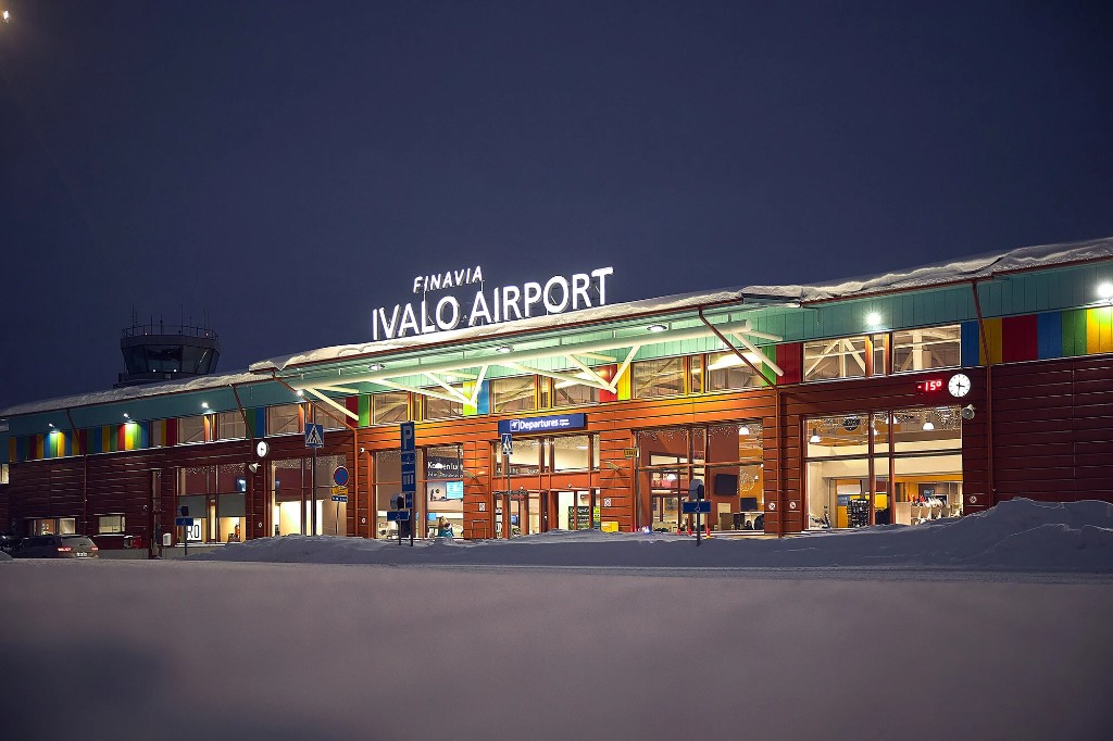 Ivalo Airport terminal lit at night, snow-covered Lapland departure