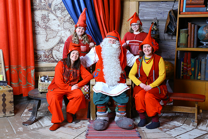 Santa Claus at his office with visitors
