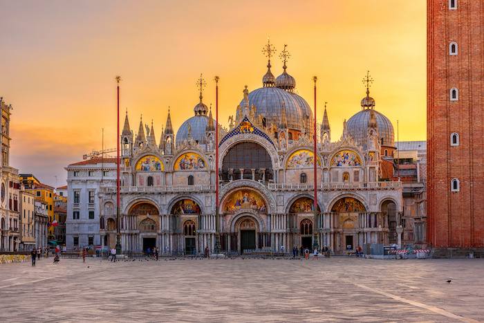 St. Mark’s Basilica façade and domes above Piazza San Marco at sunset, Venice