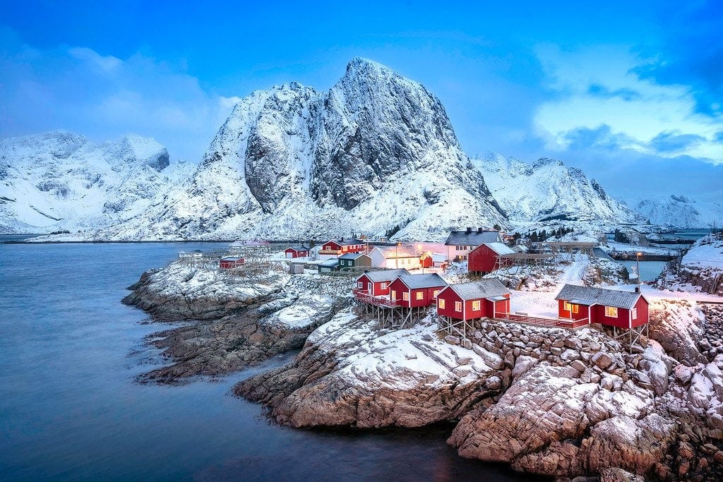 Lofoten coastal cabins and snowy mountains in Norway
