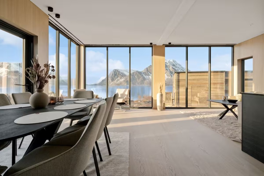 Lofoten villa open-plan living and dining with panoramic fjord and mountain windows