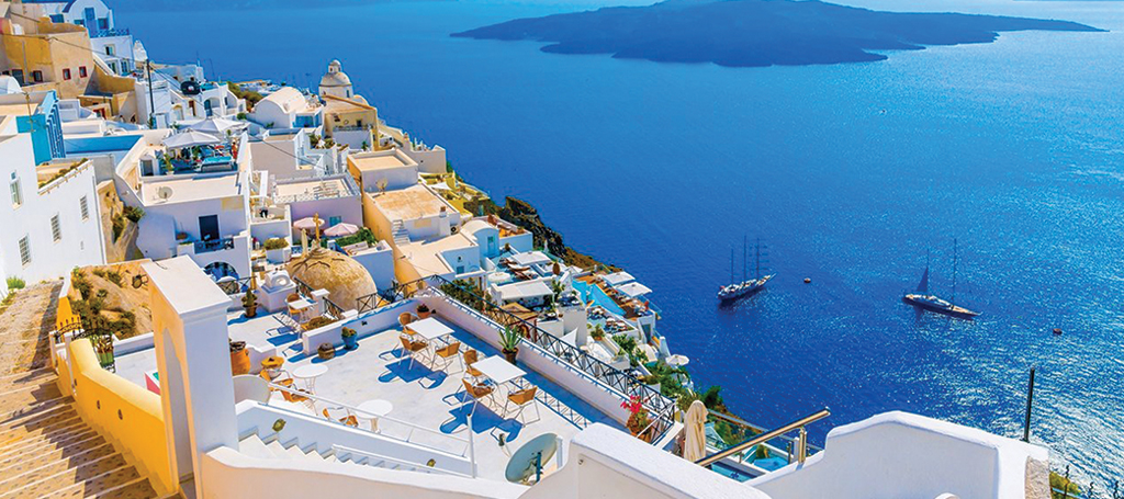 Whitewashed houses and blue domes above the Aegean